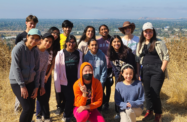 A group of people posing for a photo

Description automatically generated